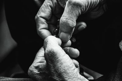 Close-up of hands holding praying beads