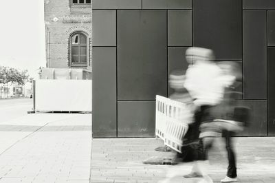 Blurred motion of man walking on street