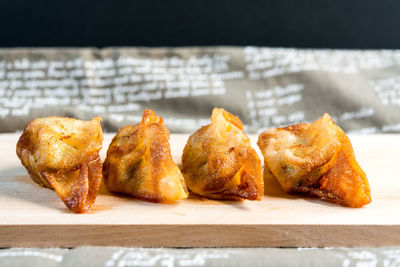 Close-up of dumplings on table against black background