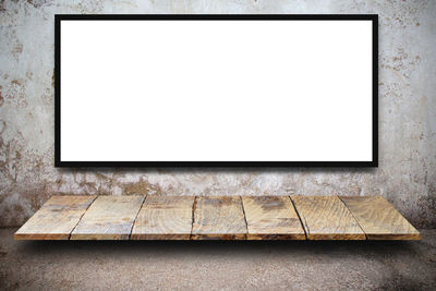 Empty picture frame against wall