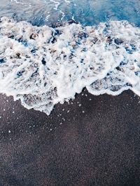 High angle view of surf on beach