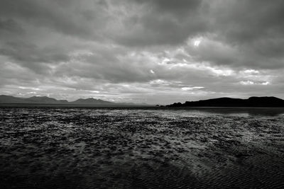 Scenic view of sea against storm clouds