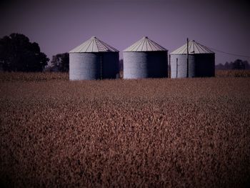 Barn on field against clear sky