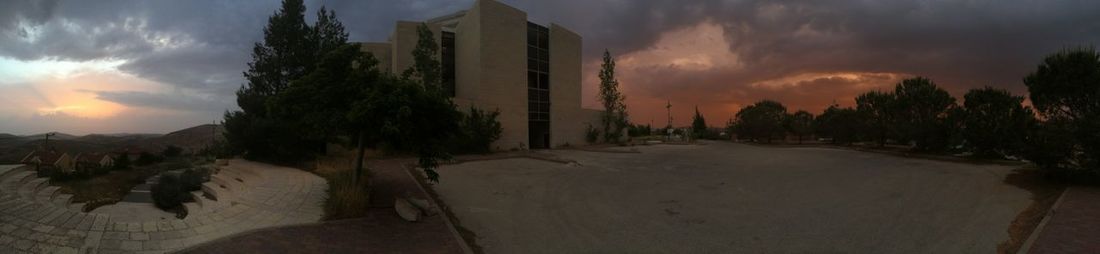 Building against cloudy sky at sunset