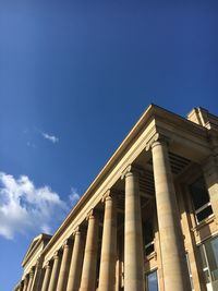 Low angle view of government building against blue sky