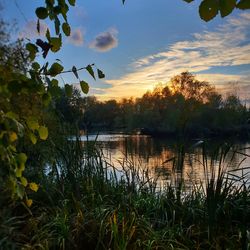 Scenic view of lake against sky during sunset