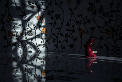 Reflection of woman standing in water