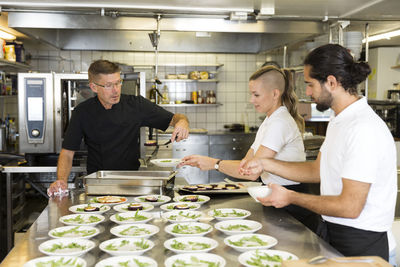 People working in restaurant kitchen