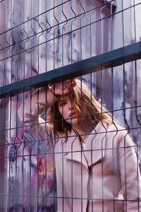 Portrait of teenage girl seen through railing