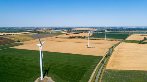 Scenic view of agricultural field against clear sky