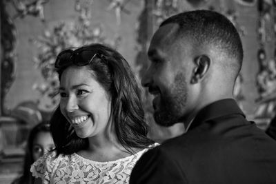 Close-up of smiling couple looking away indoors