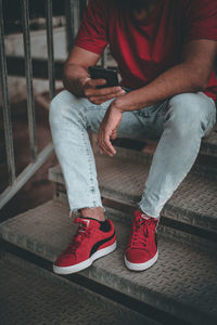 Low section of man sitting on staircase