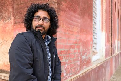 Young man standing against wall