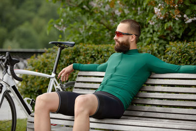 Young man sitting on bench