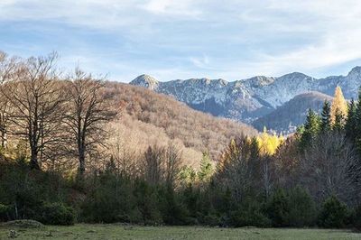 Scenic view of mountains against cloudy sky