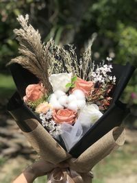 Close-up of hand holding flower bouquet