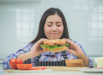 Close-up of woman eating sandwich