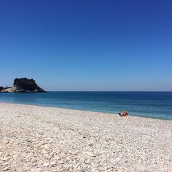 Scenic view of sea against clear blue sky