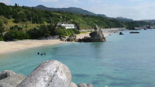 Scenic view of sea and mountains against sky