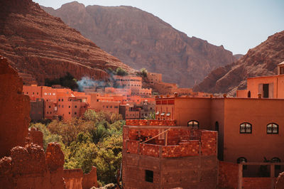 Buildings in town against mountains