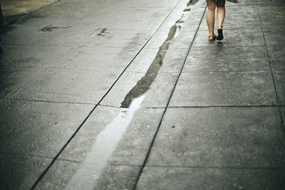 Low section of woman standing on tiled floor