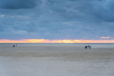 Scenic view of beach against sky during sunset