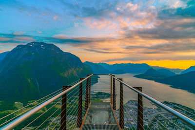 Bridge over mountain against sky during sunset