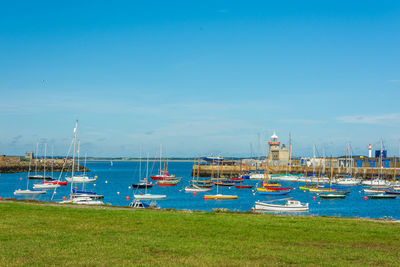 Boats moored in sea against sky