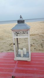 Lifeguard hut on beach against sky