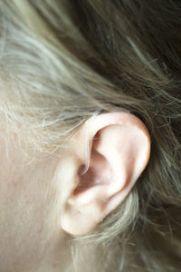 Close-up of woman with hearing aid