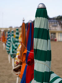 Close-up of umbrellas at beach