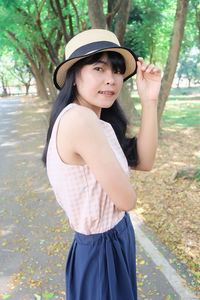 Portrait of smiling young woman in park