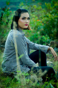 Young woman sitting on field