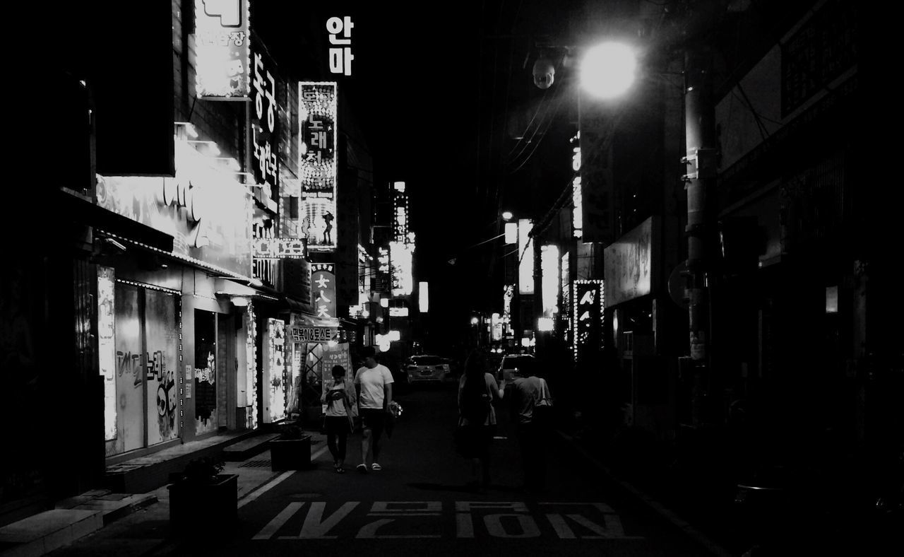 VIEW OF ILLUMINATED STREET AT NIGHT