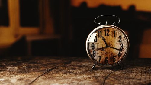 Close-up of clock on table