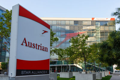 Information sign by building against sky