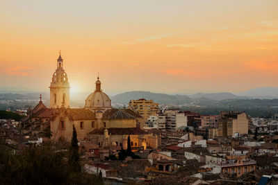 High angle view of buildings in city at sunset