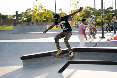 Full length of man skateboarding on skateboard in city