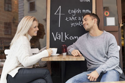 Young couple spending leisure time at outdoor cafe