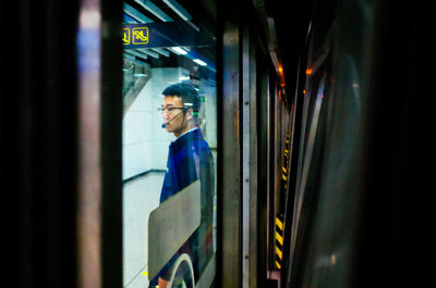 Reflection of man in train