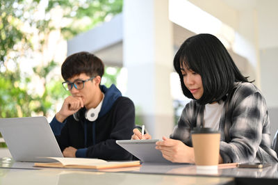 Young woman using laptop at table