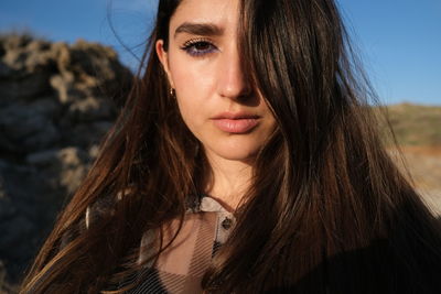 Portrait of beautiful woman against sky