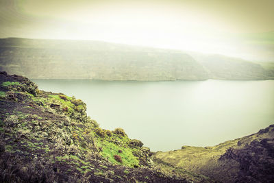 Scenic view of lake and mountains against sky