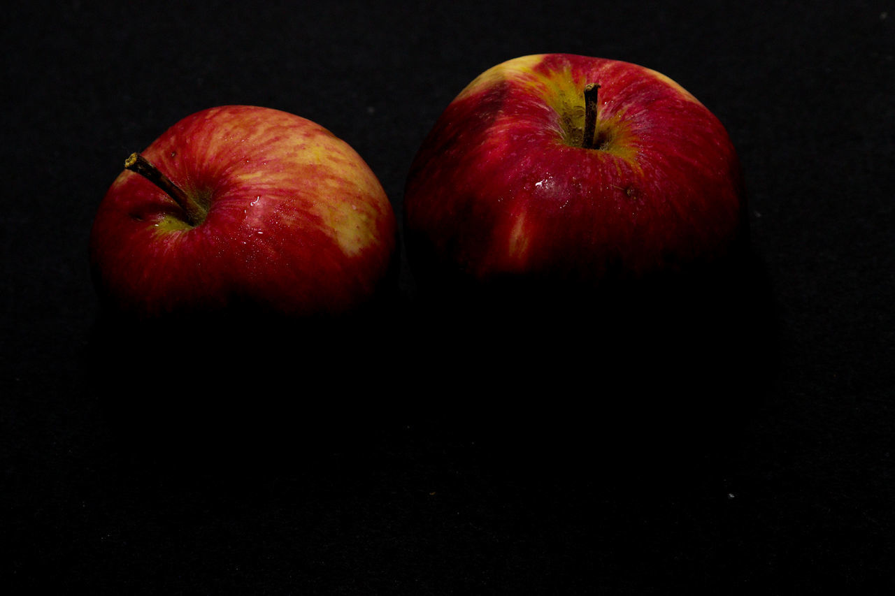 CLOSE-UP OF APPLE ON RED TABLE