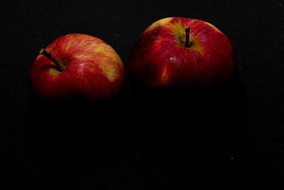 Close-up of apples on apple against black background