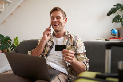 Young woman using laptop while sitting at home