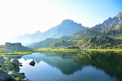 Scenic view of lake and mountains against sky