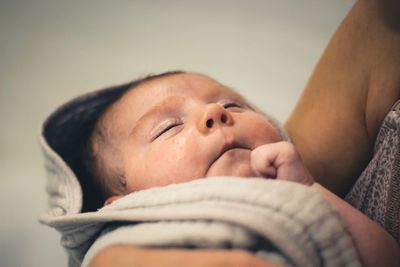 Close-up of baby girl sleeping at home