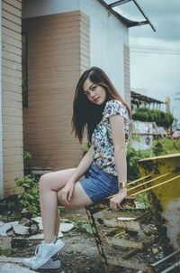 Portrait of young woman sitting outdoors