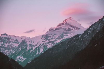 Scenic view of snowcapped mountains against sky during sunset